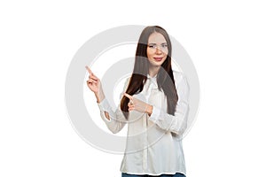 Young, beautiful girl in a white shirt on a white background