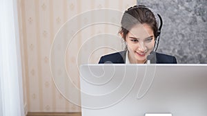 Young beautiful girl working at a laptop in a small medium enterprise
