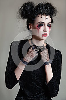 Young beautiful gothic woman with white skin and red lips. Halloween