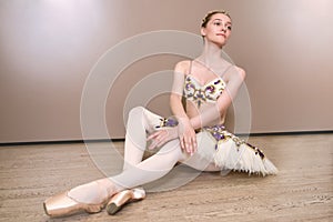 Young beautiful graceful caucasian ballerina practice ballet positions in tutu skirt