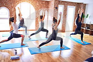 Young beautiful group of sportswomen practicing yoga