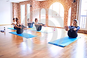 Young beautiful group of sportswomen practicing yoga