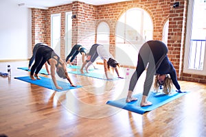 Young beautiful group of sportswomen practicing yoga