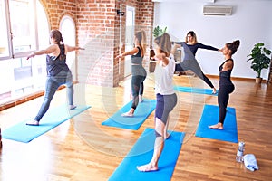 Young beautiful group of sportswomen practicing yoga