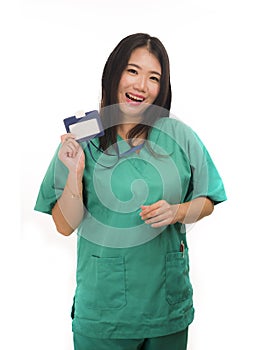 Young beautiful and happy Asian Chinese medicine doctor woman or hospital nurse in green scrubs posing cheerful smiling confident
