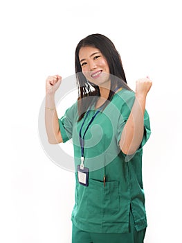 Young beautiful and happy Asian Chinese medicine doctor woman or hospital nurse in green scrubs posing cheerful smiling confident