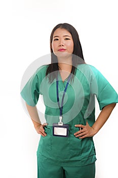 Young beautiful and happy Asian Korean medicine doctor woman or hospital nurse in green scrubs posing cheerful smiling confident