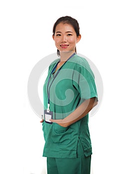 Young beautiful and happy Asian Korean medicine doctor woman or hospital nurse in green scrubs posing cheerful smiling confident