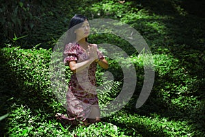 Young beautiful and happy Asian Korean woman in stylish dress exploring nature at tropical island jungle feeling fresh and relaxed