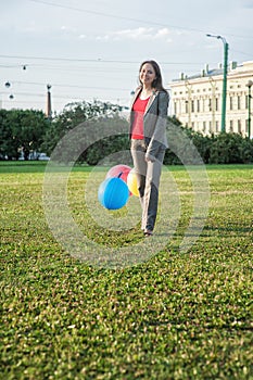 Young beautiful happy business woman with long hair walking with air balloons outdoor