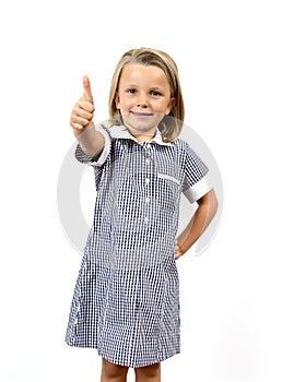 Young beautiful and happy child girl 6 to 8 years old blond hair and blue eyes smiling excited wearing school uniform isolated on