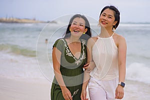 Young beautiful and happy couple of attractive Asian Chinese women walking together relaxed at the beach enjoying holidays in gay