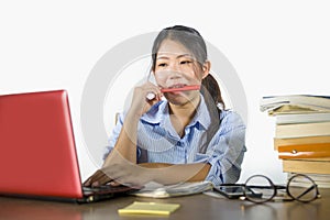 Young beautiful and happy efficient Asian Korean student girl working on project with laptop computer smiling confident sitting on