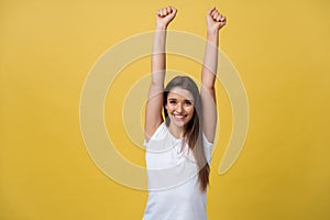 Young beautiful happy girl portrait on yellow background.