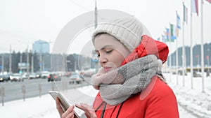 Young beautiful happy girl smiling portrait and chatting on the street in winter