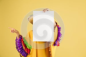 Young beautiful happy girl in sombrero isolated over yellow background.