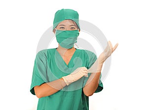 Young beautiful and happy medicine doctor or chief hospital nurse in green scrubs and surgey hat and mask wearing protective latex