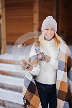 Young beautiful happy smiling girl holding sparkler. Christmas, New Year, concept.