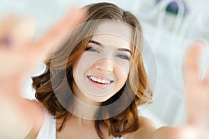 Young beautiful happy smiling woman waking up on bed