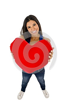 Young beautiful and happy woman holding red cushion heart shape smiling isolated in white