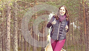 Young, beautiful and happy woman walking in forest. Camp, advent