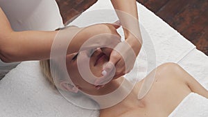 Young, beautiful and healthy woman in spa salon. Traditional Thai massage therapy and skin care.