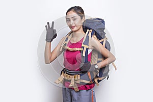 Young beautiful hiker asian woman with a backpack feeling tired isolated on white background