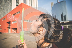 Young beautiful hipster woman bubble blower