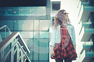 Young beautiful hipster woman with red curly hair