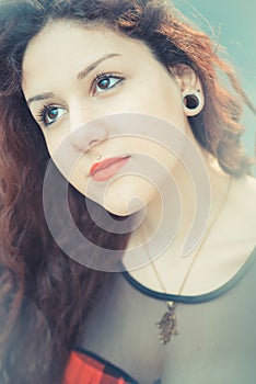 Young beautiful hipster woman with red curly hair