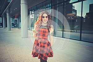 Young beautiful hipster woman with red curly hair