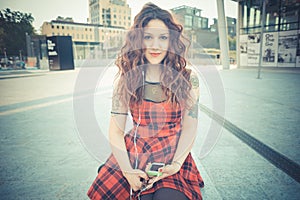 Young beautiful hipster woman with red curly hair