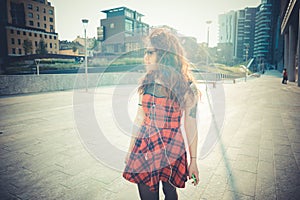 Young beautiful hipster woman with red curly hair