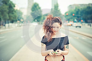 Young beautiful hipster woman with red curly hair