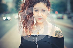 Young beautiful hipster woman with red curly hair