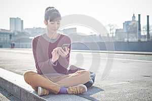 Young beautiful hipster woman using smart phone