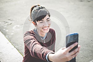 Young beautiful hipster woman using smart phone