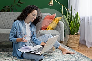 Young beautiful Hispanic female student studying remotely online at home