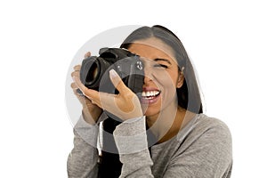 Young beautiful hispanic photographer woman smiling happy taking photo with reflex camera