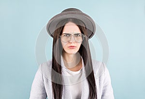 Young beautiful hispanic sad woman serious and concerned looking worried and thoughtful facial expression feeling depressed