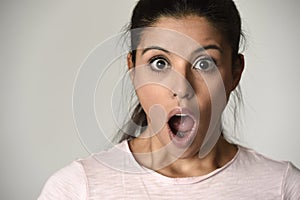 Young beautiful hispanic surprised woman amazed in shock and surprise with mouth big opened