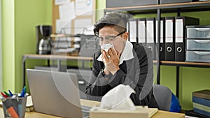 Young beautiful hispanic woman business worker being sick using napkin at office