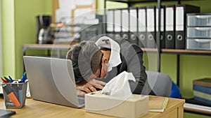 Young beautiful hispanic woman business worker being sick using napkin at office