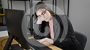 Young beautiful hispanic woman business worker tired using computer working at office