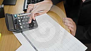 Young beautiful hispanic woman business worker using calculator accounting at office