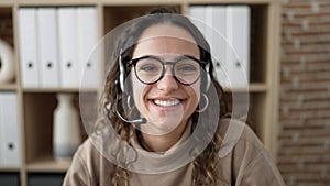 Young beautiful hispanic woman call center agent smiling confident working at office