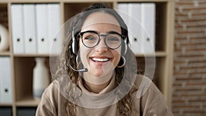 Young beautiful hispanic woman call center agent smiling confident working at office