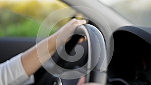 Young beautiful hispanic woman driving a car on the road