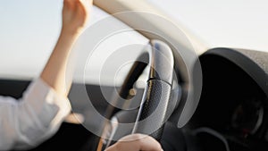 Young beautiful hispanic woman driving a car on the road