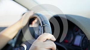 Young beautiful hispanic woman driving a car on the road